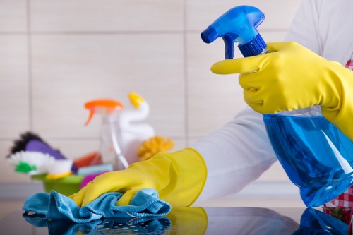 Trained carpet cleaner wearing protective gloves and shoes